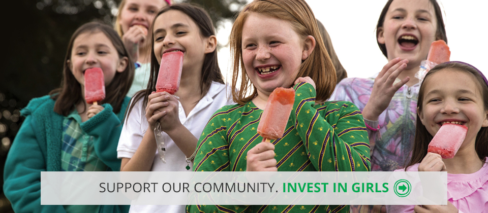 HOME_HERO-DONATE Image of girls smiling with popsicles with the words "Support our community. Invest in girls"