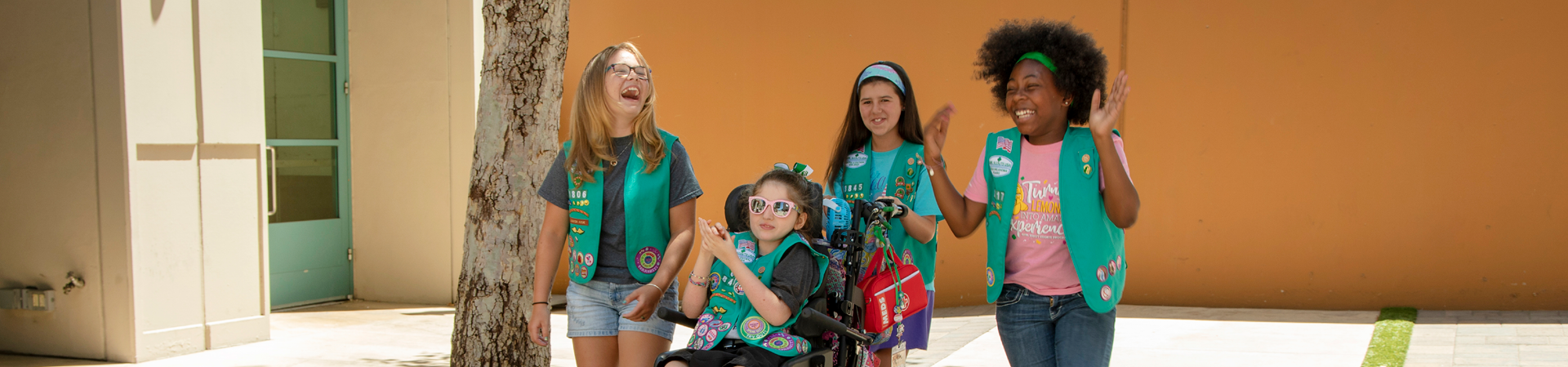  Group of Girl Scouts smiling at each other outdoors 